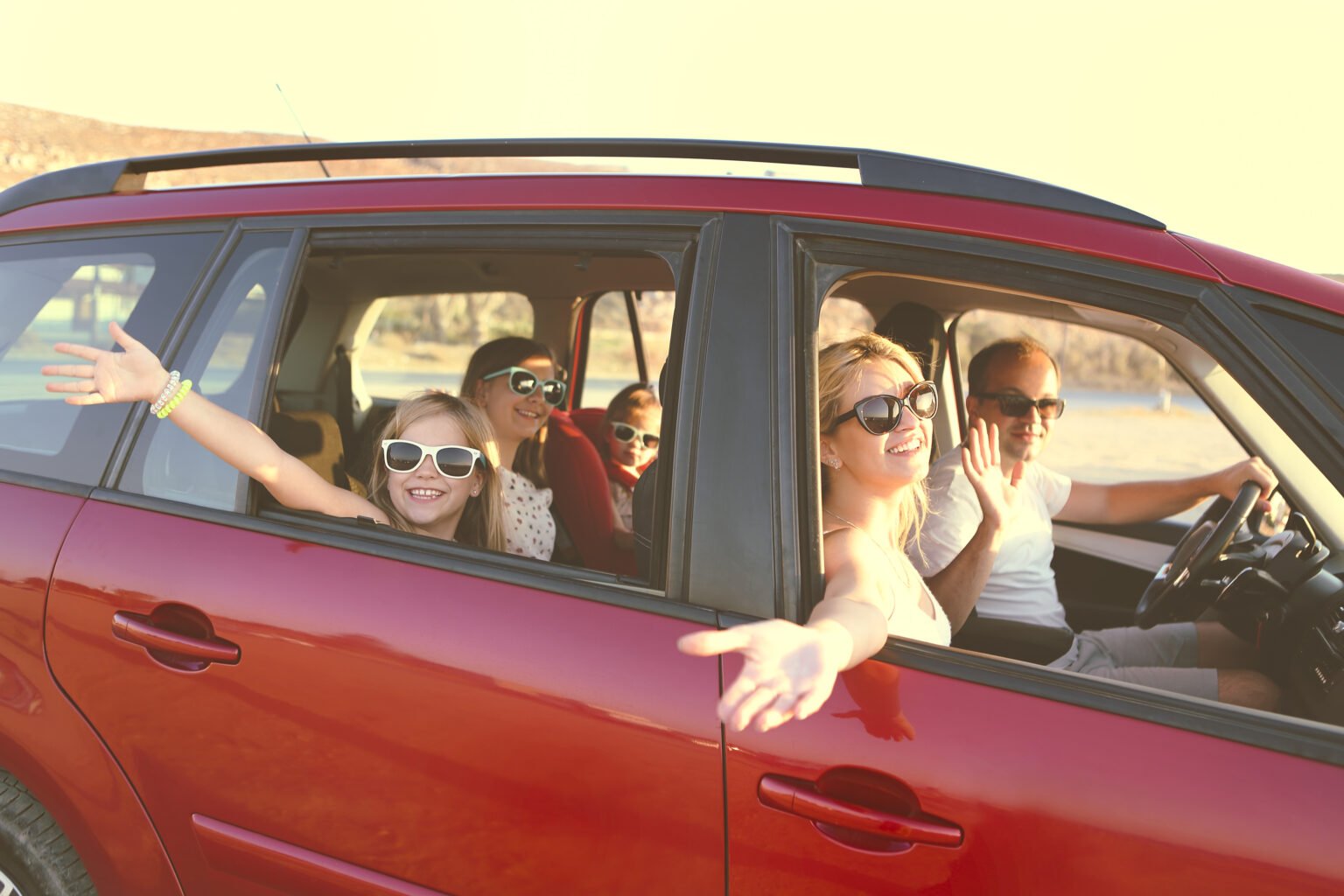 large family in a red car 1536x1024 1
